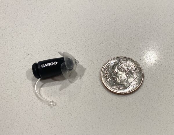 Eargo hearing aid compared to a dime.